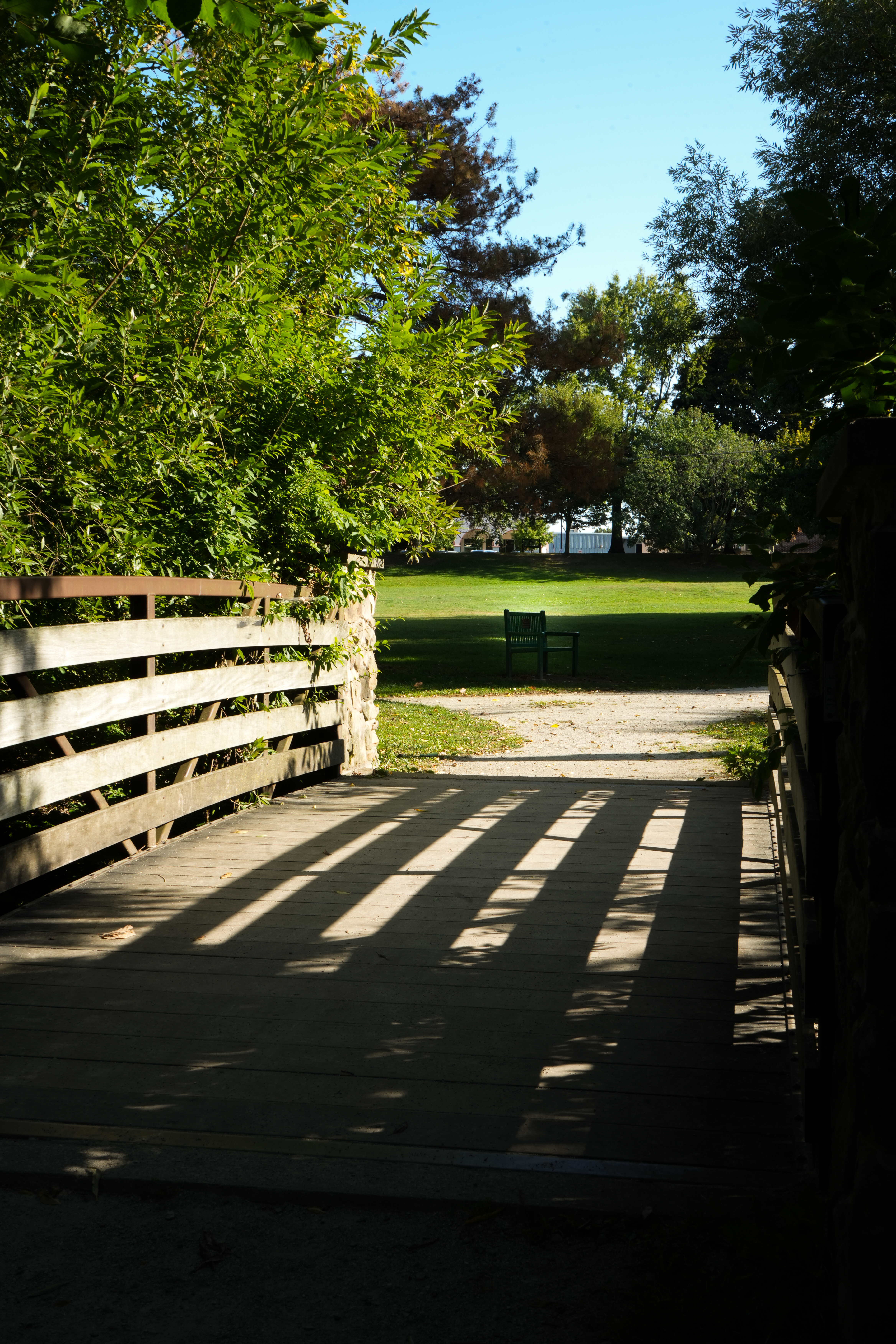 Wooden footbridge crossing a shaded path in Frontier Park