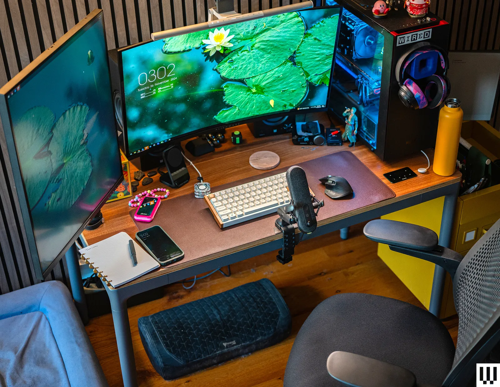 Desk with laptop, notebook, and creative tools symbolizing digital work.